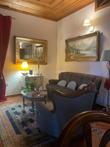 a living room with a couch and a table at Casa Major in Pegarinhos