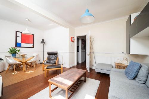 a living room with a couch and a table at A Charming 1BR apartment in Bromley in Bromley