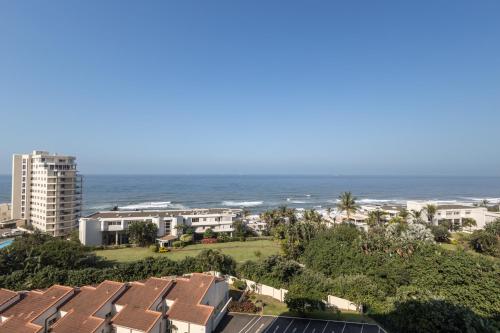 a view of the ocean from the balcony of a resort at 63 Sea Lodge - by Stay in Umhlanga in Durban
