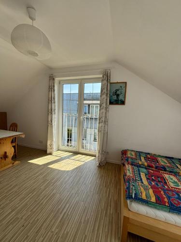 a bedroom with a bed and a large window at Apartament u Zosi in Wisełka
