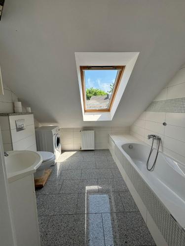 a bathroom with a toilet and a sink and a window at Apartament u Zosi in Wisełka
