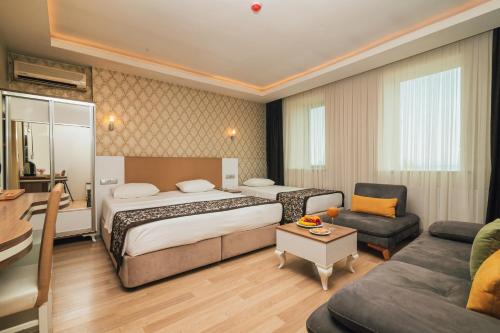מיטה או מיטות בחדר ב-Konak Park Hotel
