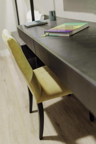 a desk with a chair and a book on it at Grand Brizo Bel Air in Buenos Aires