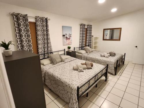 a hotel room with two beds in a room at Walk to Hard Rock ~ Amazing 5 Star Home Away From Home! in Miami Gardens