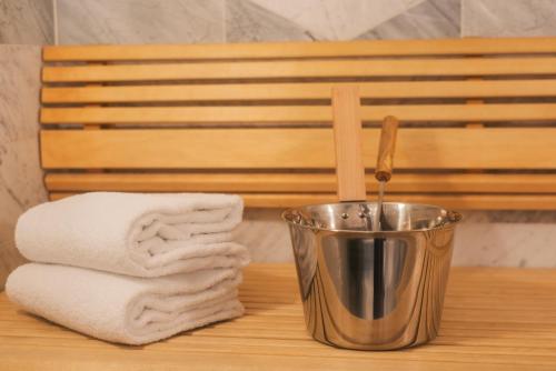 a metal trash can sitting on a table with a towel at Hotel Hasselbacken in Stockholm