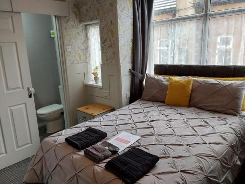 a bedroom with a bed with two towels on it at The Woodleigh family hotel in Blackpool