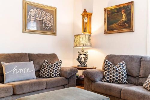 a living room with two couches and a table at Serenity House near Gaslamp, San Diego Zoo & Petco in San Diego