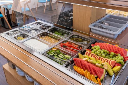 a buffet filled with different types of fruits and vegetables at Botel Racek in Prague