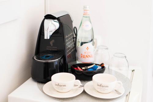 a table with two cups and a bottle of wine at Bed and Brekfast Donatella in Piran