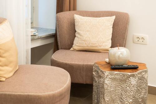 a chair with a pillow and a candle on a table at Bed and Brekfast Donatella in Piran