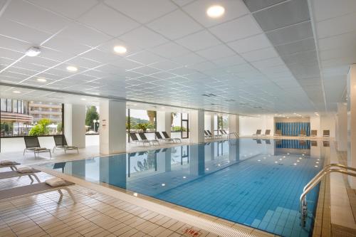 a large swimming pool in a building at Remisens Hotel Albatros-All inclusive in Cavtat