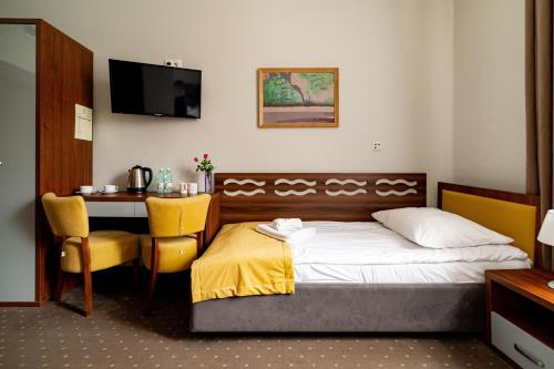 Ένα ή περισσότερα κρεβάτια σε δωμάτιο στο Nowe Łazienki Mineralne