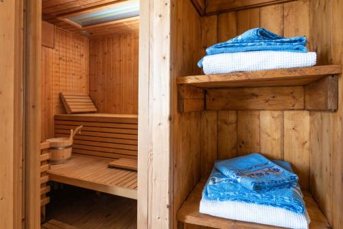 a wooden sauna with wooden shelves and towels at Villa Arta in Medulin in Medulin