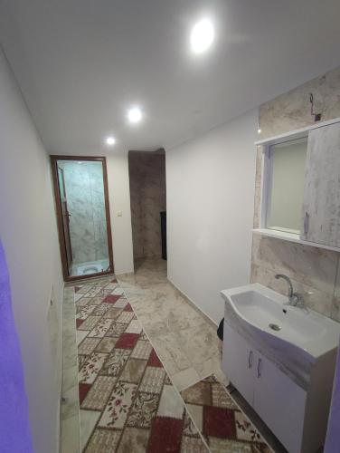 a bathroom with a sink and a tile floor at AYDIN HOME Uzungöl in Uzungöl