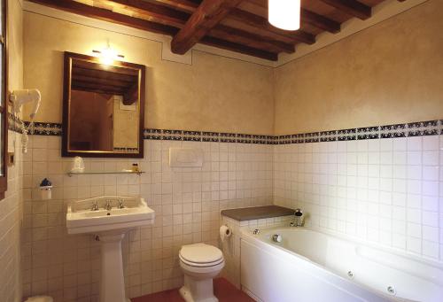 a bathroom with a tub and a toilet and a sink at B&B Palazzo Al Torrione 2 in San Gimignano