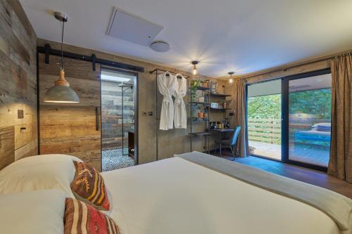 a bedroom with a bed and a sliding glass door at Fermain Valley Hotel in St Peter Port