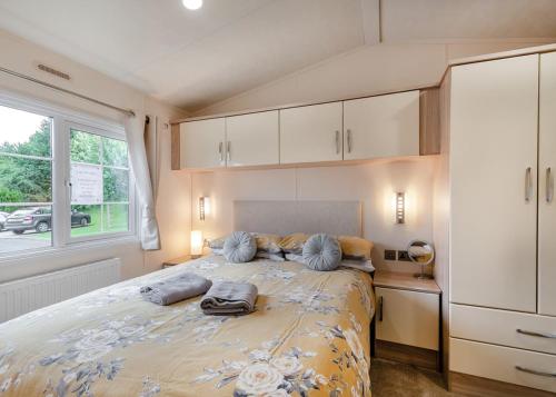 a bedroom with a large bed and a window at Riverview Holiday Park in Newcastleton