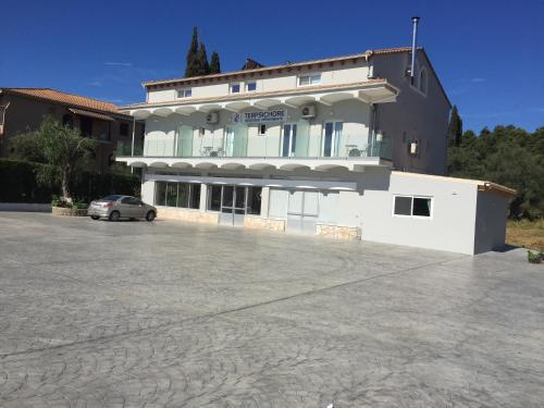 a building with a car parked in front of it at Terpsichore Boutique Appartments in Dassia