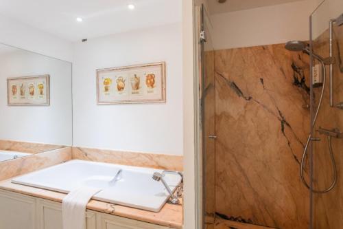 a bathroom with a shower and a sink at Hotel Le Verger Maelvi in Grimaud
