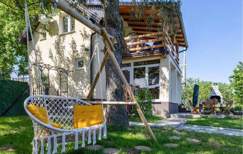a swing in front of a house at Awesome Home In Aljmas in Aljmaš