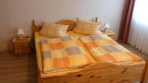 a bedroom with two beds with pillows and two lamps at Zenner's Landhotel in Newel