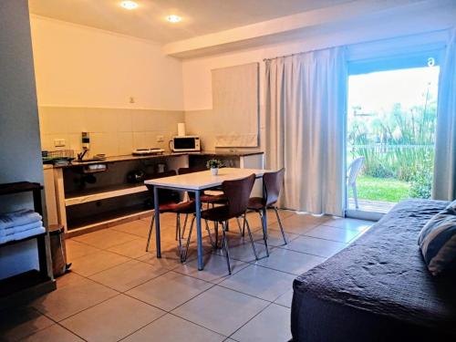 a kitchen with a table and chairs in a room at Amanzi Termal Rental in Concordia