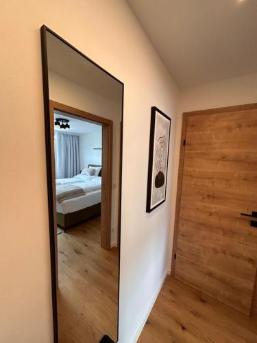 a mirror in a room with a bed and a bedroom at Ferienwohnung Silvia, Mondsee Zentrum in Mondsee