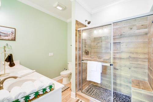 a bathroom with a shower and a toilet at Waterfront Wolf Bay Home with Private Boathouse! in Elberta