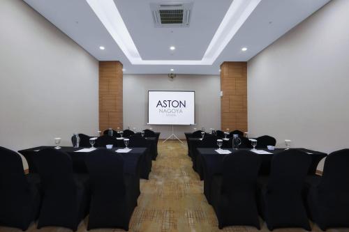 a conference room with black chairs and a screen at Aston Nagoya City Hotel in Nagoya