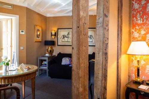 a living room with a couch and a table at Hôtel Le Relais Saint-Germain in Paris