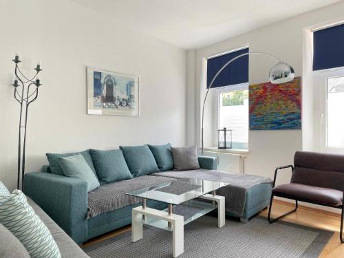 a living room with a couch and a table at Gemütliches Apartment, Seenähe, WM, WLAN, Balkon in Markkleeberg