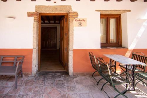 a patio with tables and chairs in a building at Hospedium Hotel Rural Abadía de Yuste in Cuacos de Yuste
