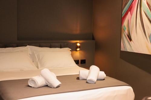 a bedroom with a bed with towels on it at Bel Ami Tirana in Tirana