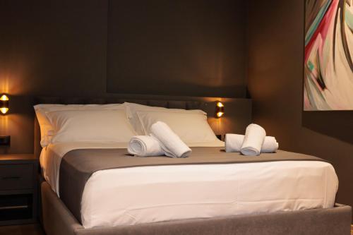 a bedroom with a bed with two towels on it at Bel Ami Tirana in Tirana
