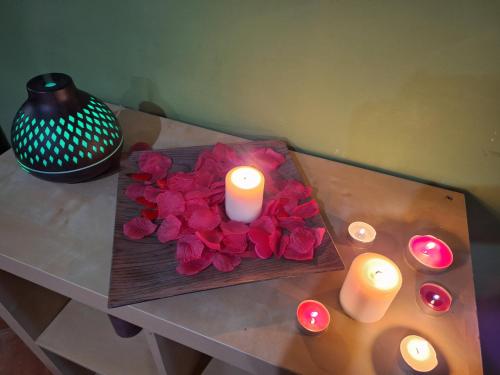a table with a bouquet of roses and candles at Al Vicoletto in Fabrica di Roma