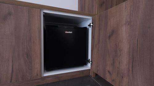 a tv in a wooden cabinet with a window at Belvedere rooms A&E in Velika Kladuša