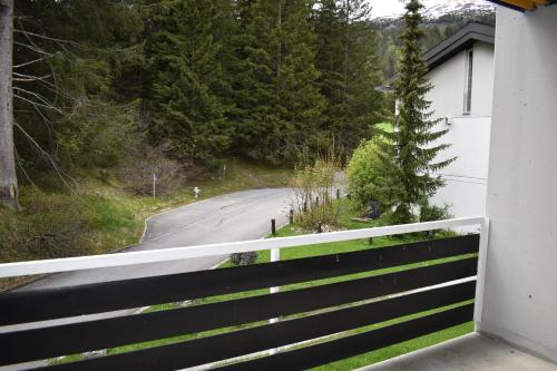 a winding road next to a house with a fence at Las Bargias 5 402 Mi in Lenzerheide