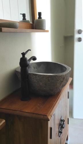 a stone sink on top of a wooden cabinet at Elva House in Panormos