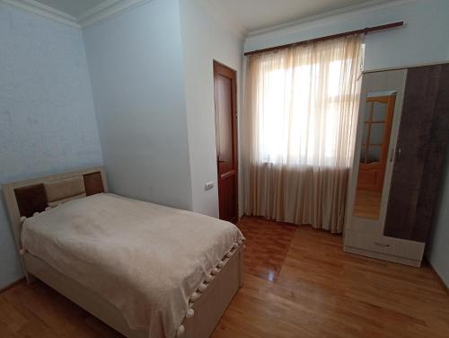 a bedroom with a bed and a window and a door at Green Paradise in Ijevan