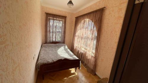 a small bedroom with a bed and a window at Green Paradise in Ijevan