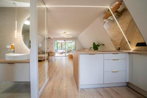 a bathroom with white cabinets and a sink at Beach Brothers House Domki nad jeziorem Nyskim in Skorochów
