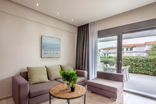 a living room with a couch and a table at Villa Selena seafront in Hanioti