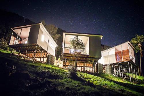 a house on top of a hill at night at Byron Bay Hinterlands Dreaming Woods Cabin Three in Bangalow