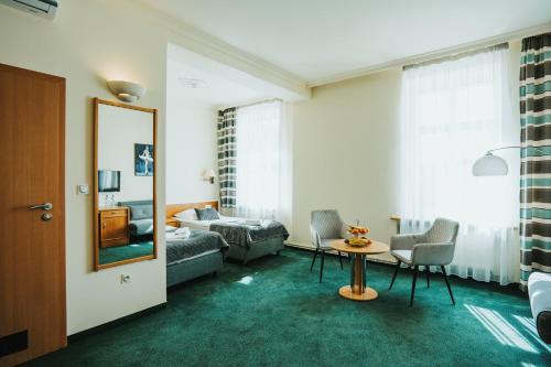 a living room with a couch and a table at Polonia Raciborz in Racibórz