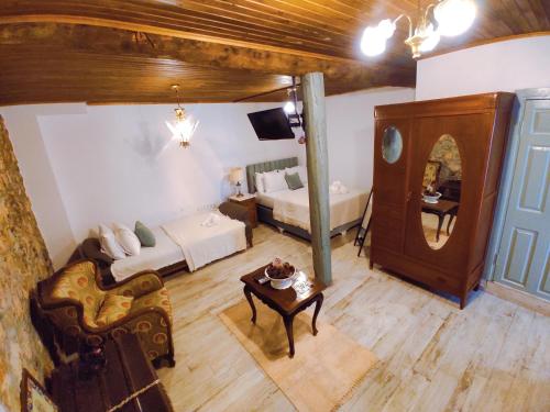 a living room with a bed and a mirror at Kidoni Macaron Guesthouse in Ayvalık