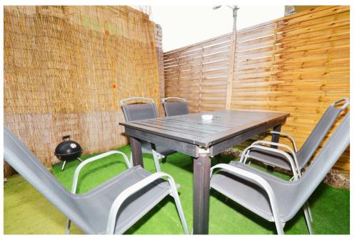 a wooden table and chairs on a patio at Relax apartment in Bratislava