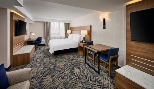 a hotel room with a bed and a desk at Candlewood Suites Burlington Conference Centre, an IHG Hotel in Burlington