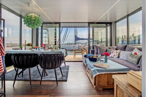 a living room with a couch and a table at Hausboot Seeadler Stralsund in Stralsund
