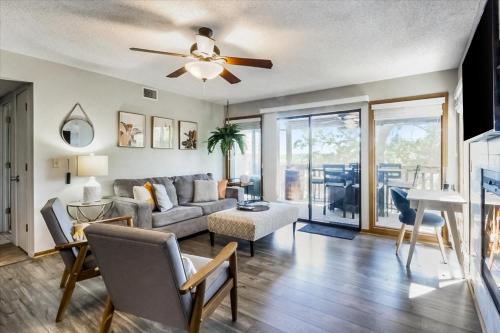 a living room with a couch and a ceiling fan at Full Moon Condo in Lake Ozark
