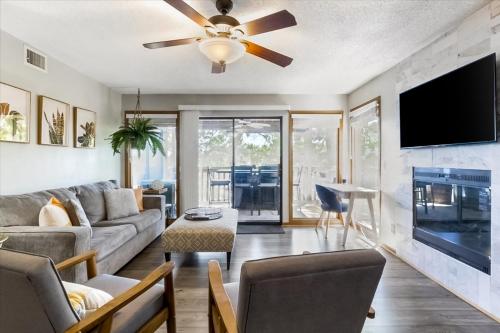 a living room with a couch and a ceiling fan at Full Moon Condo in Lake Ozark